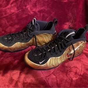 Nike Black and Gold Sneakers with Foamposite Design